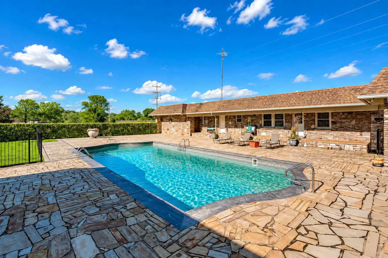 Swimming pool and stone patio at the private retreat property
